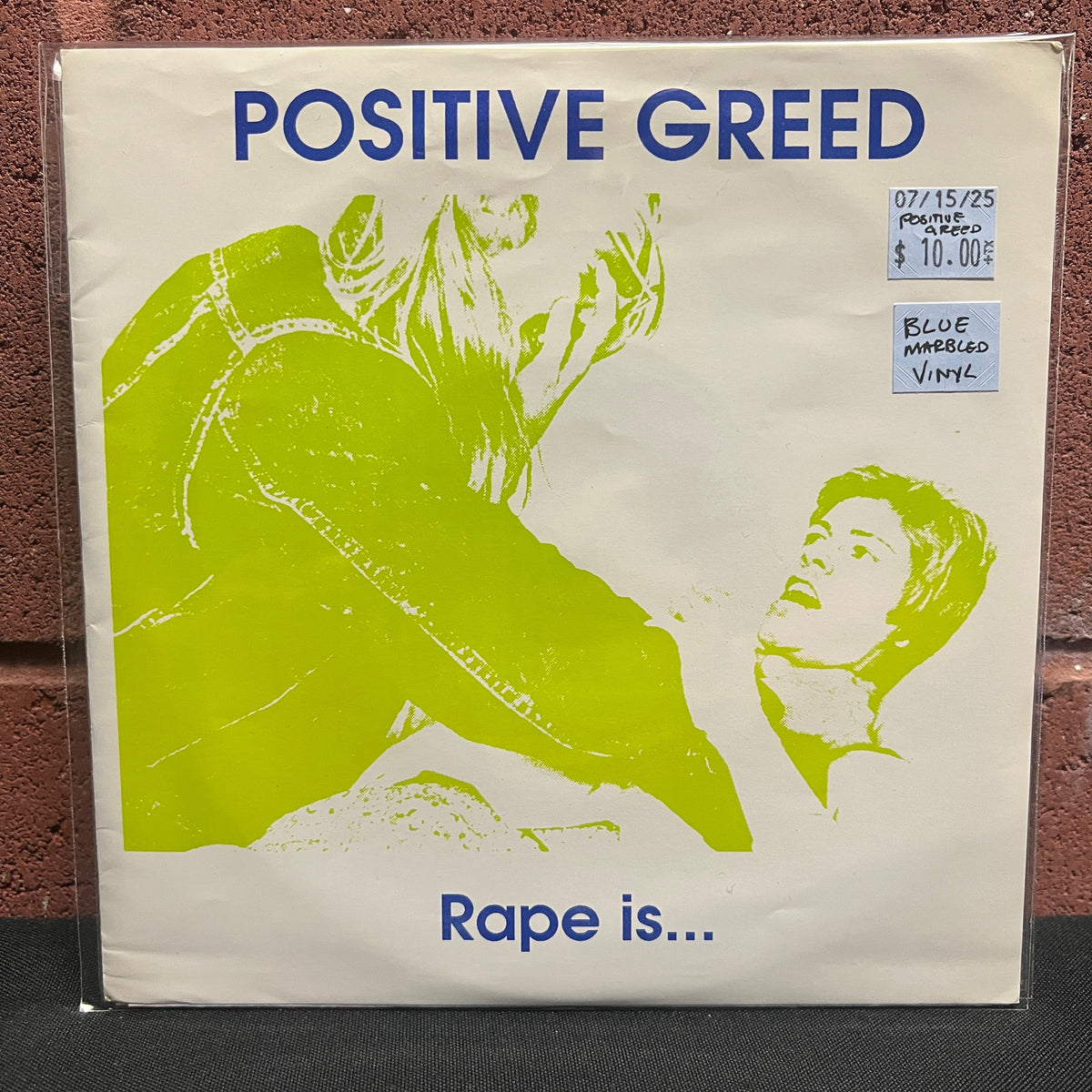 Used Vinyl: Positive Greed "Rape Is..." 7" (Blue Marbled vinyl)